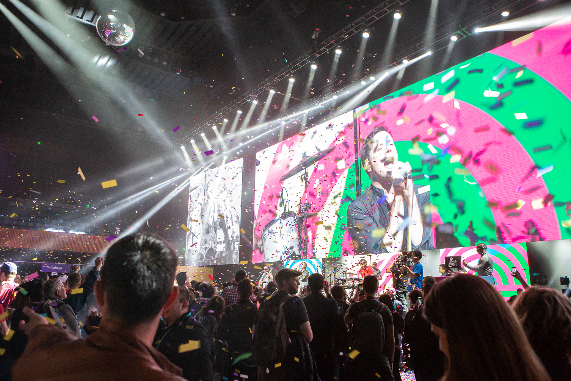 Confetti falling over the crowd during a live concert at an enterprise event